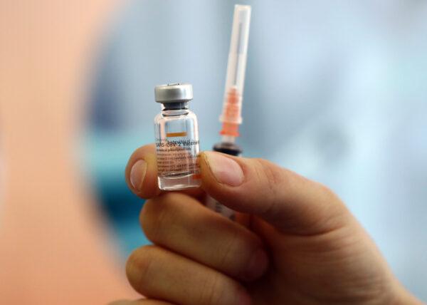 A health worker shows a dose of CoronaVac vaccine during a COVID-19 vaccination campaign in Ankara, Turkey, on Jan. 27, 2021. (Adem Altan/AFP via Getty Images)